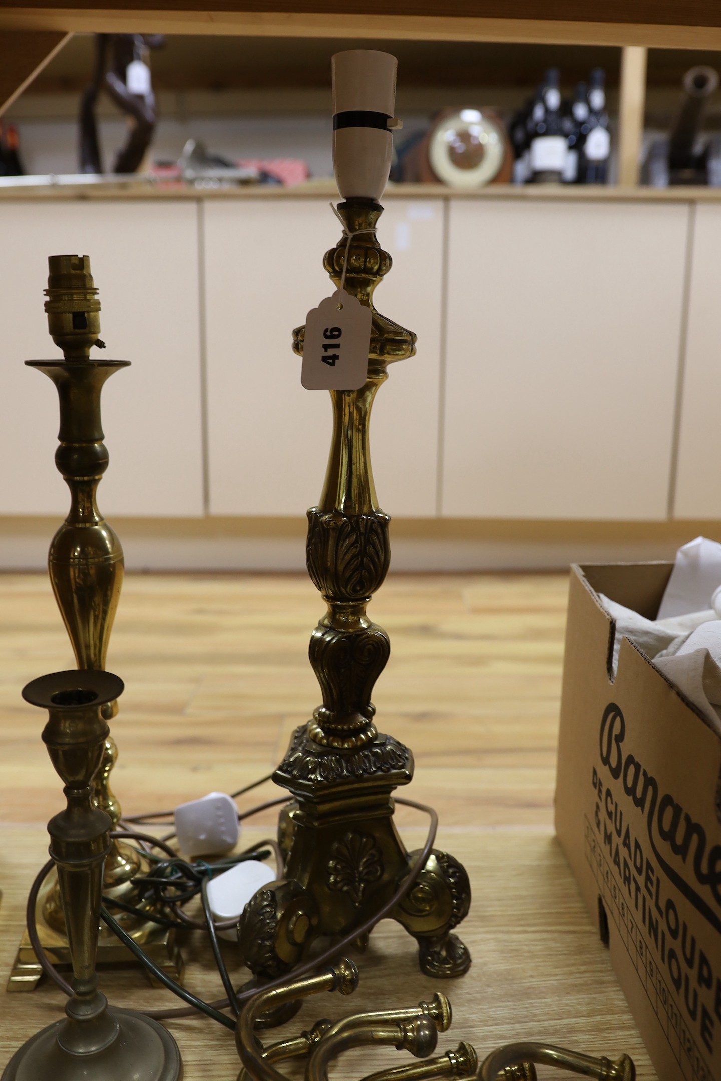 A group of mixed antique brass wares to include candlesticks, a mortar and pestle, etc